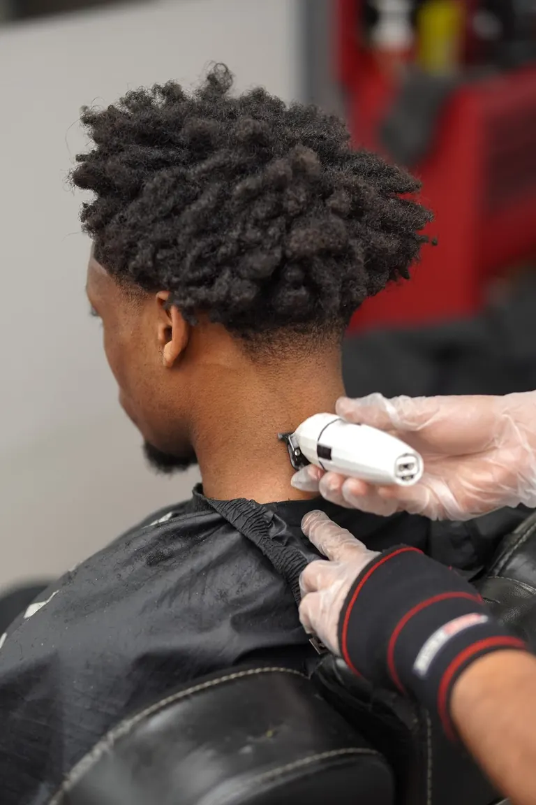 Another Level Barbers, Anerley. Clippers shaping the back of an afro.