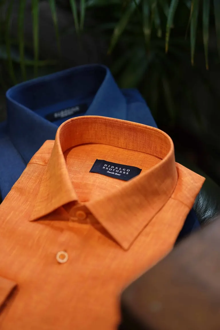 Hidalgo Brothers, Savile Row, London. Orange and navy shirts folded, close up.