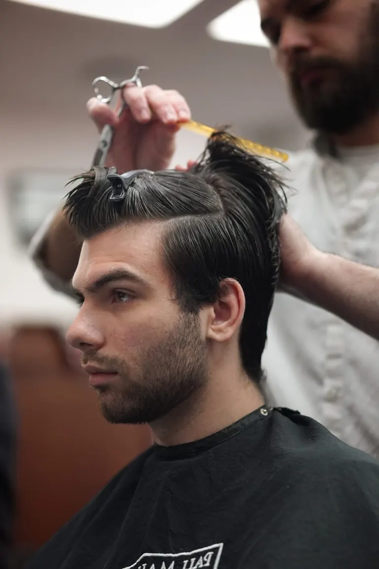Pall Mall Barbers, London. Hair sectioned and clipped, combed through mid-cut.