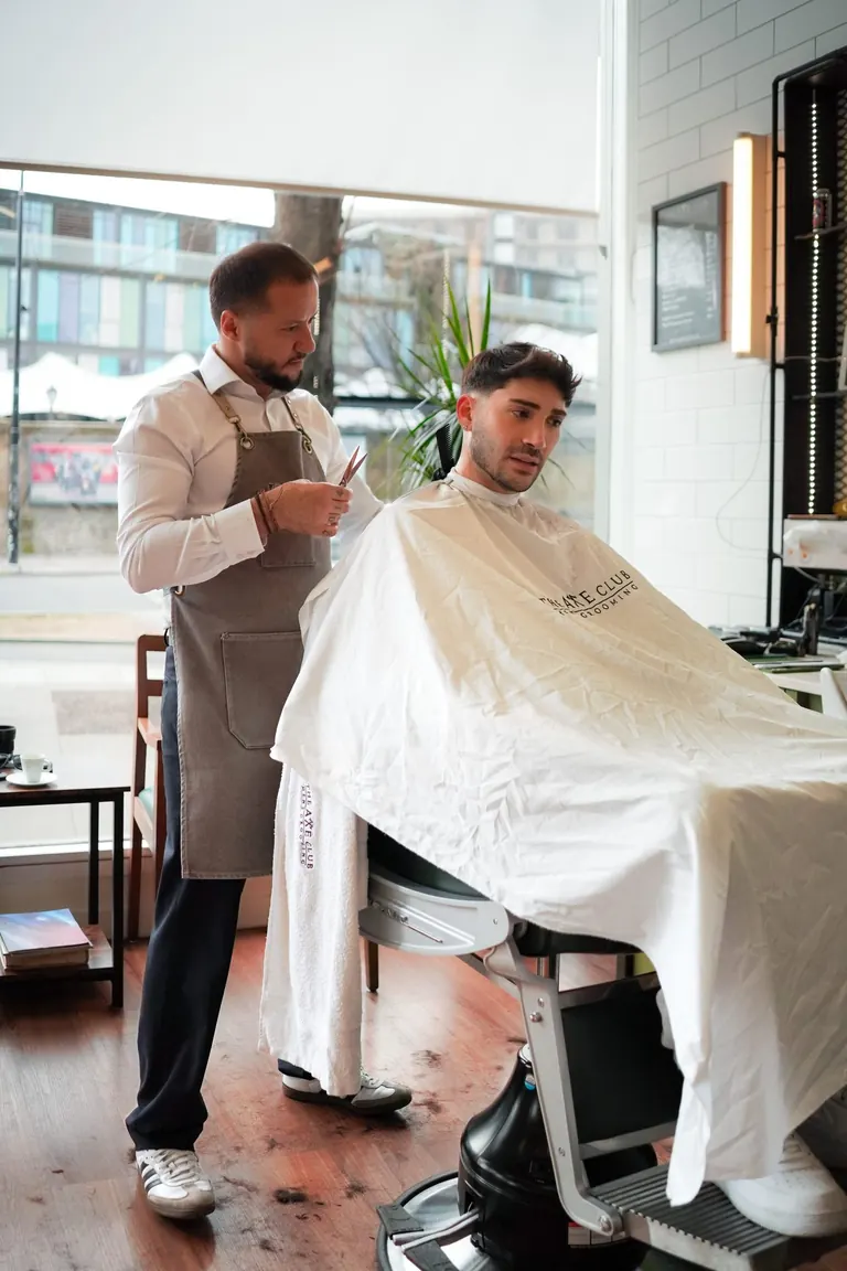 The Axe Club, London. The chair, the barber and the shop floor from across the room.