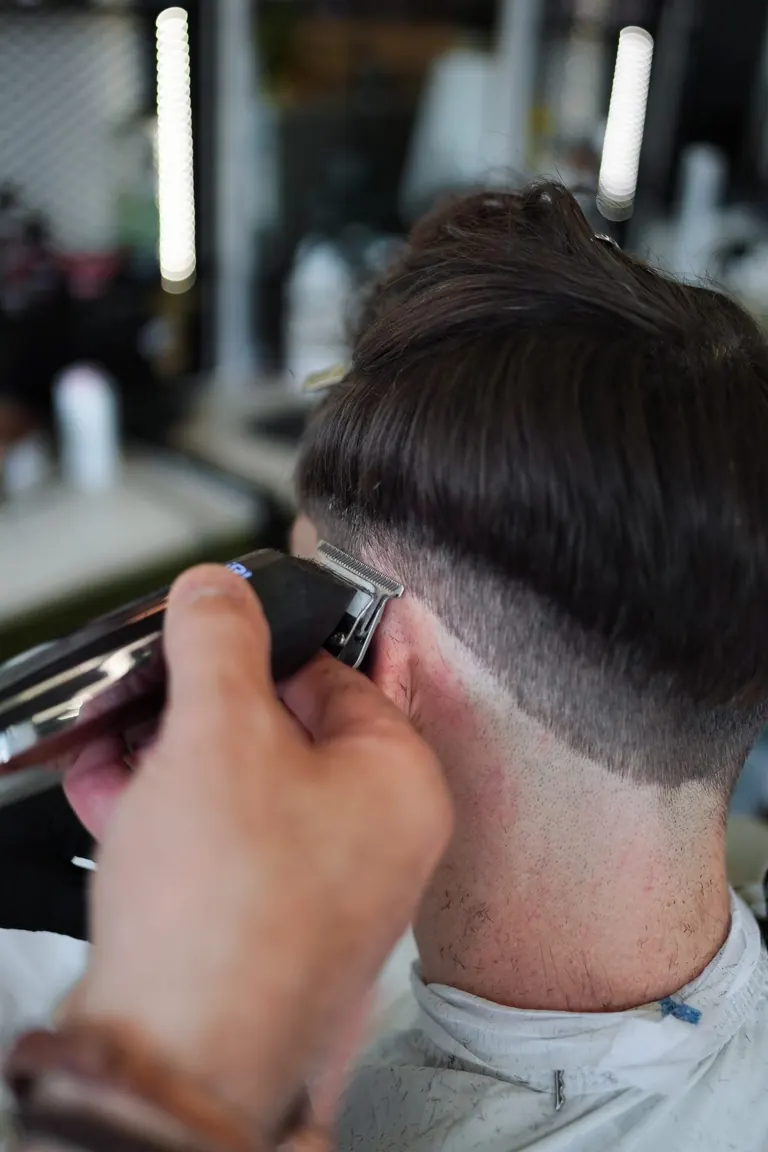 The Axe Club, London. Clippers tidy the fade at the back of the neck.
